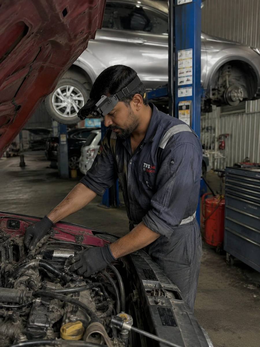 Mechanic servicing a car engine wearing a head-mounted camera
