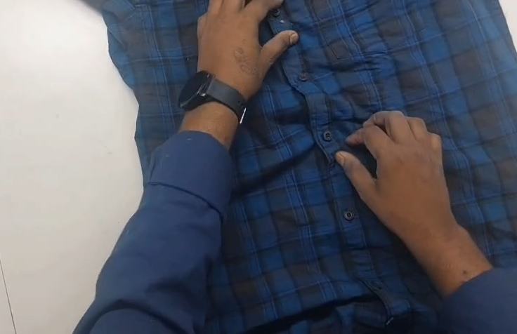 Egocentric head-mounted camera footage of a worker's hands inspecting a garment, part of The Prime Data's real-world capture archive
