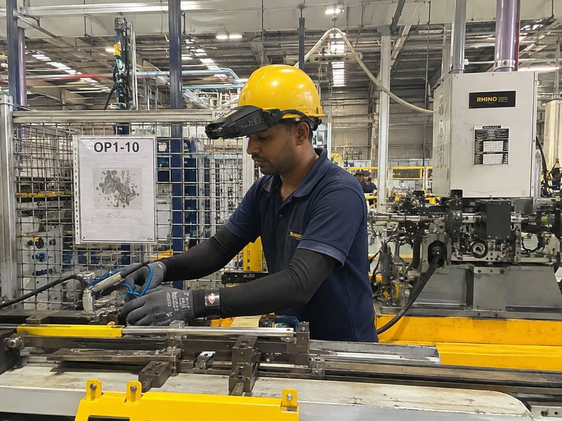 Manufacturing worker wearing a head-mounted camera on a production line