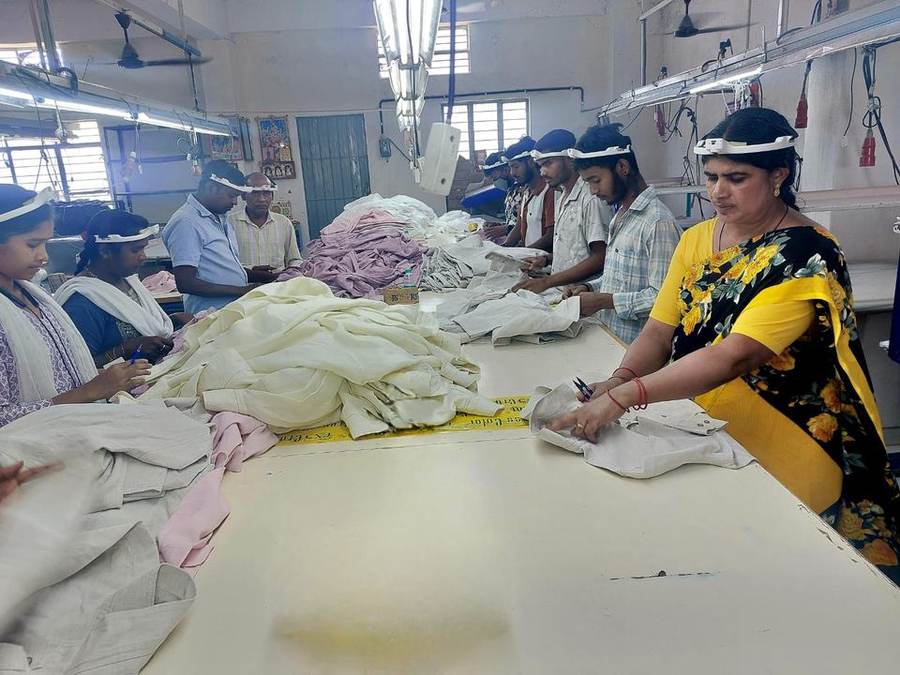 Textile factory floor with workers wearing head-mounted cameras